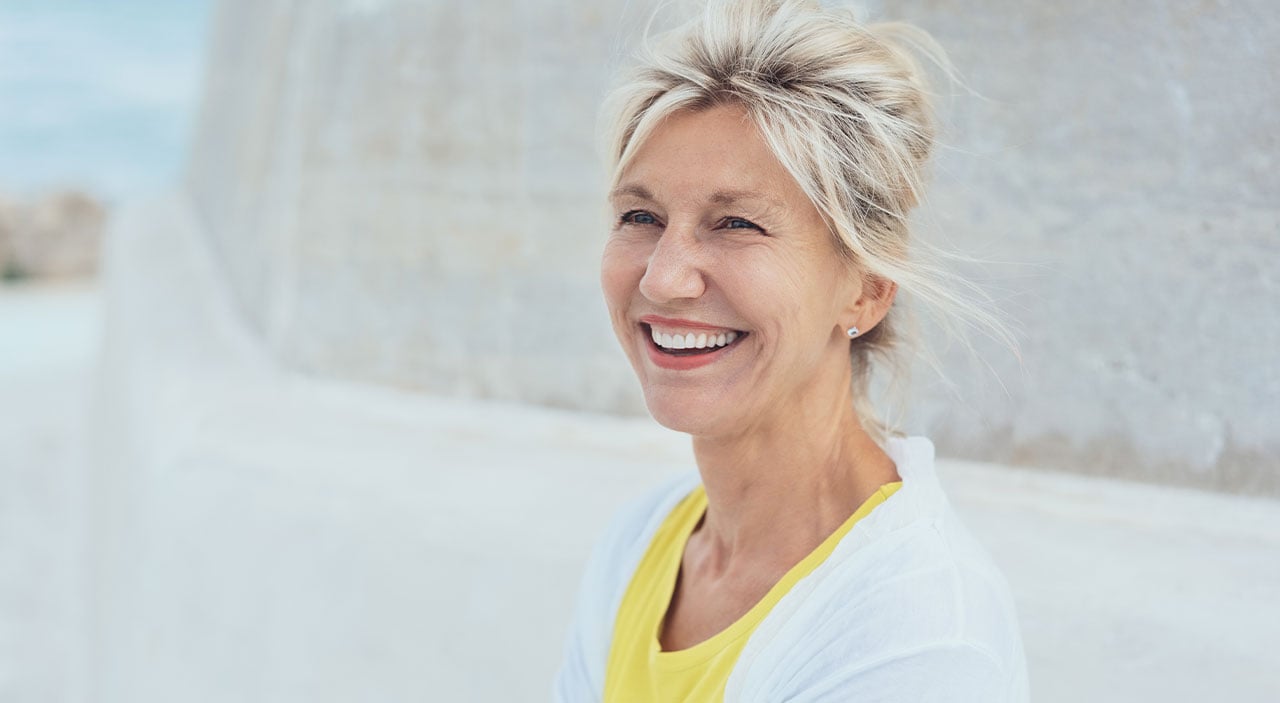 Woman with silver hair smiling.