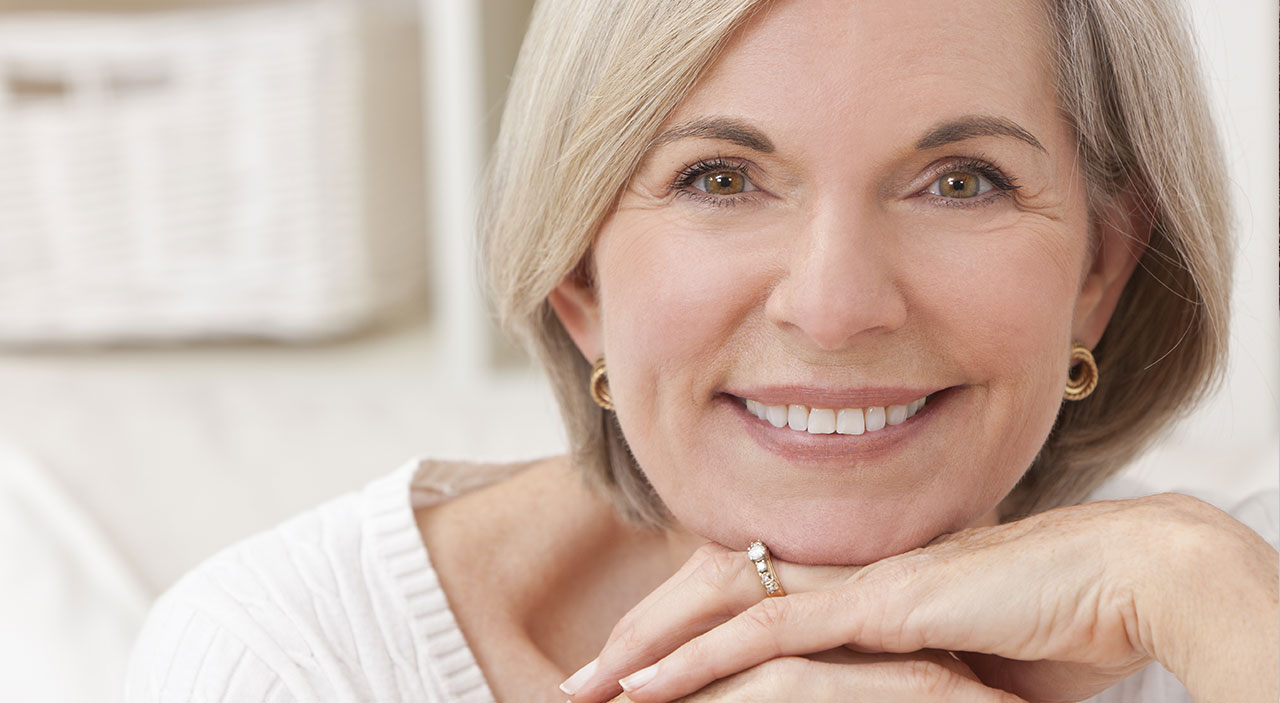 Older blonde woman smiling.