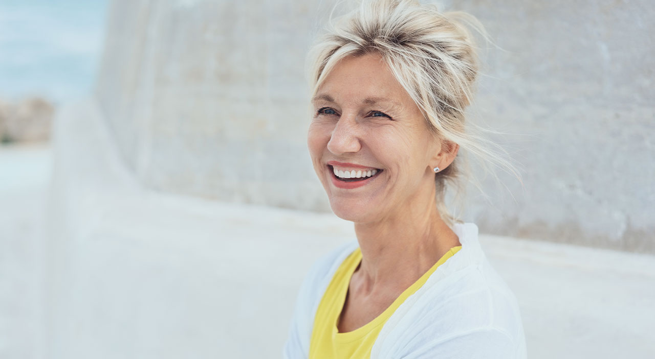 Woman with silver hair smiling.