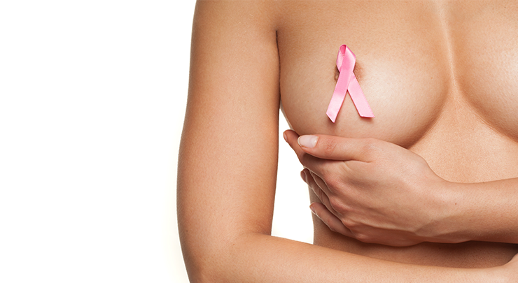 Woman with pink breast cancer ribbon on her breast.