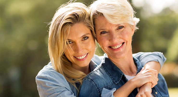 Young woman with her beautiful mother smiling.