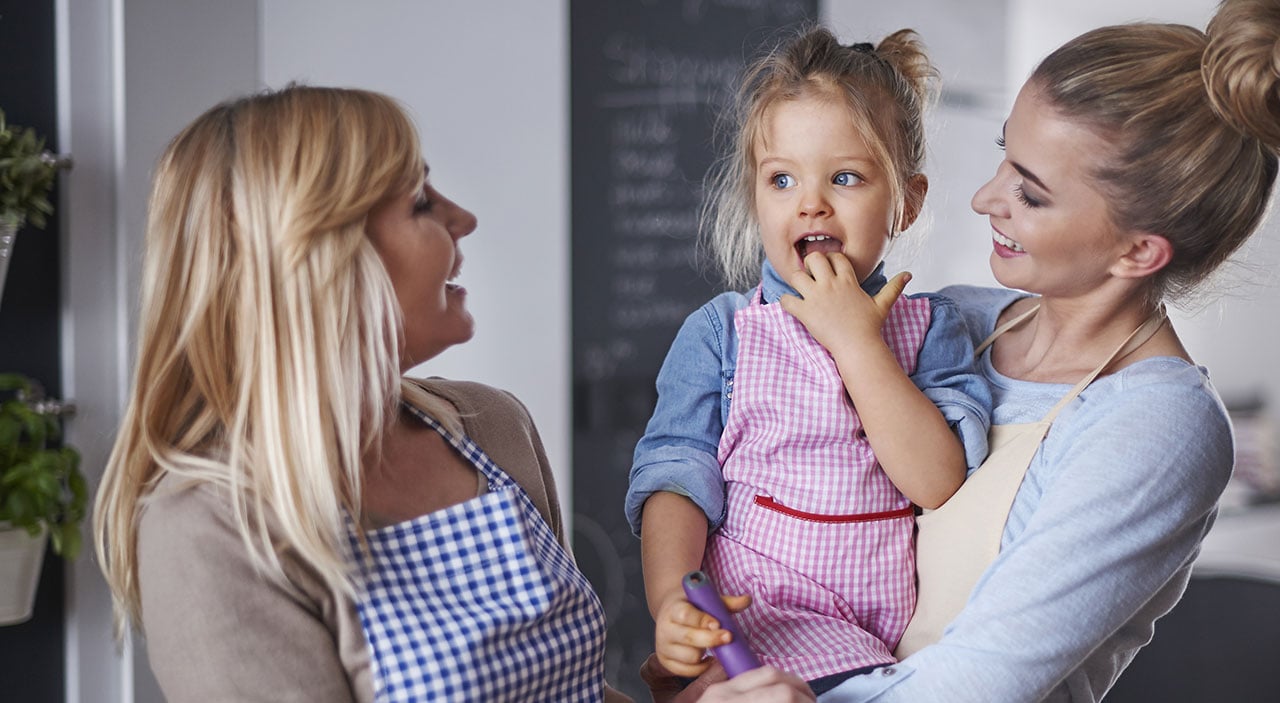 Mother and grandmother with daughter in kitchen.