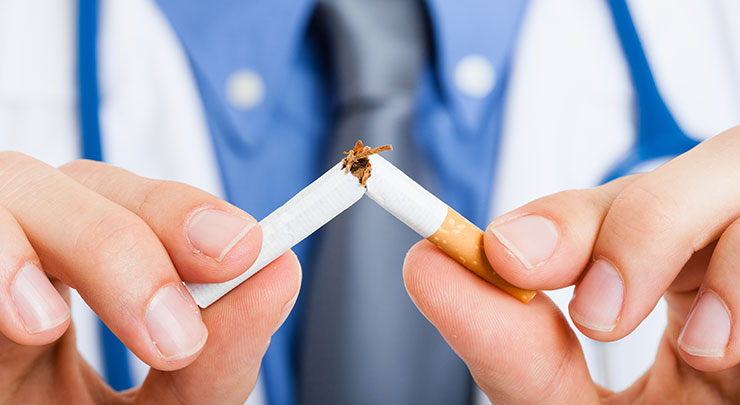 Plastic surgeon breaking cigarette in half.