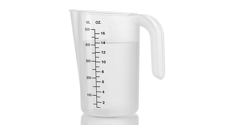 Water in measuring cup used for water test in measuring breast implant size.